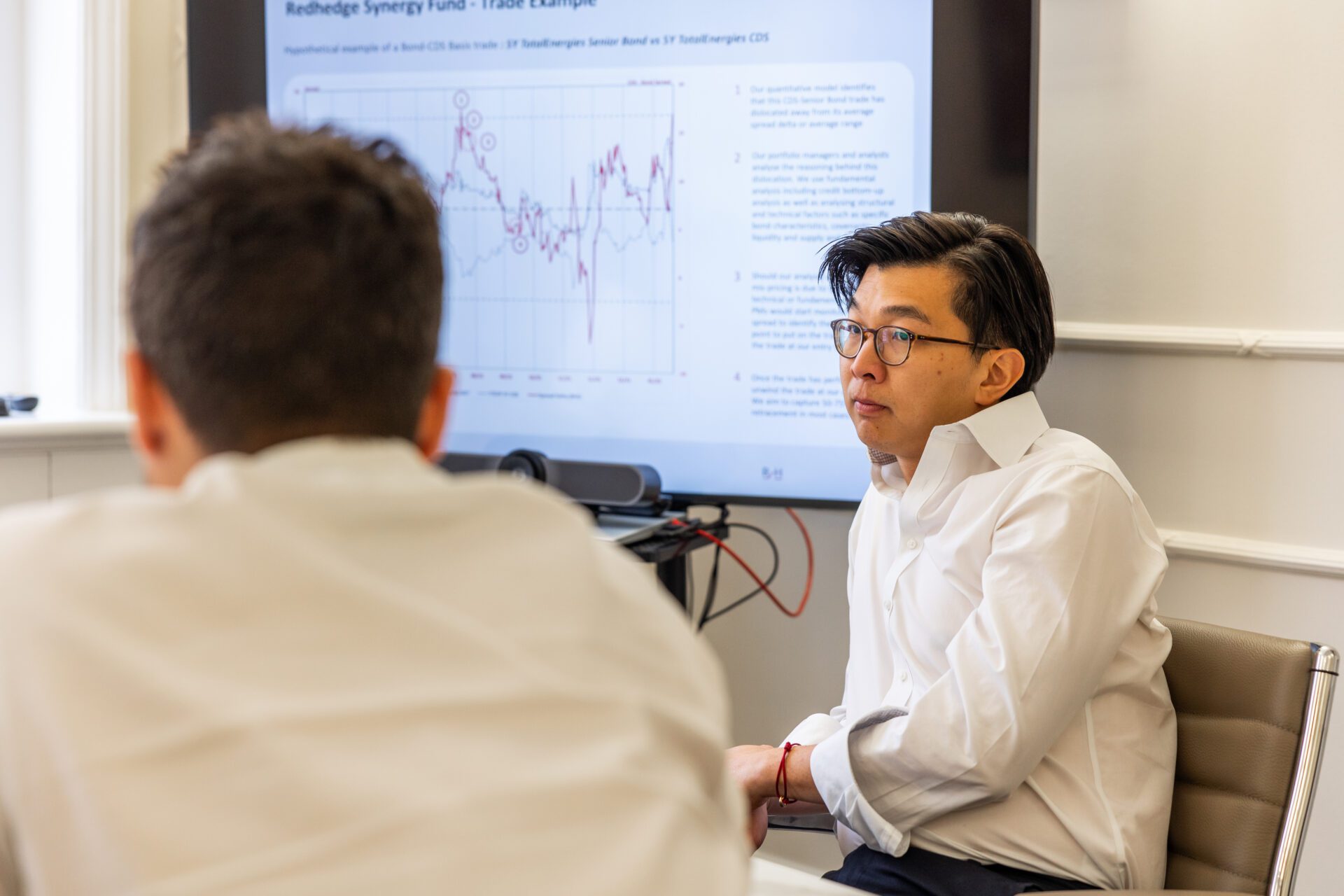 RH_2023-145 Two men in suits looking at trading monitors